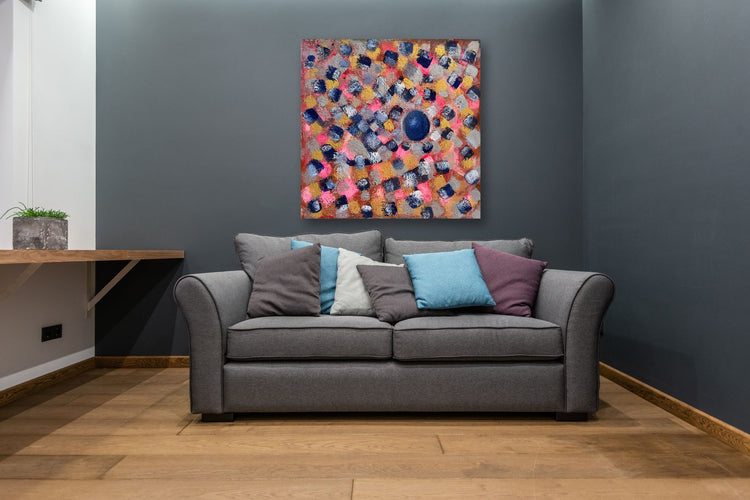 Blue Pearl — room preview on a charcoal wall above a grey sofa (preview only)