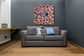 Blue Pearl — room preview on a charcoal wall above a grey sofa (preview only)