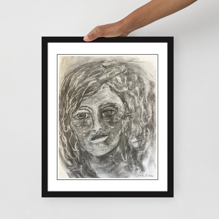 Hand holding the framed print — close-up