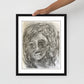 Hand holding the framed print — close-up