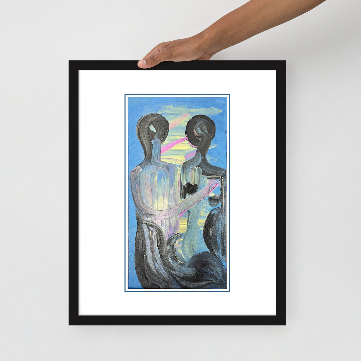 Hand holding the framed print — close-up