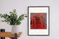 Kama Sutra in a black frame beside a plant table — room preview